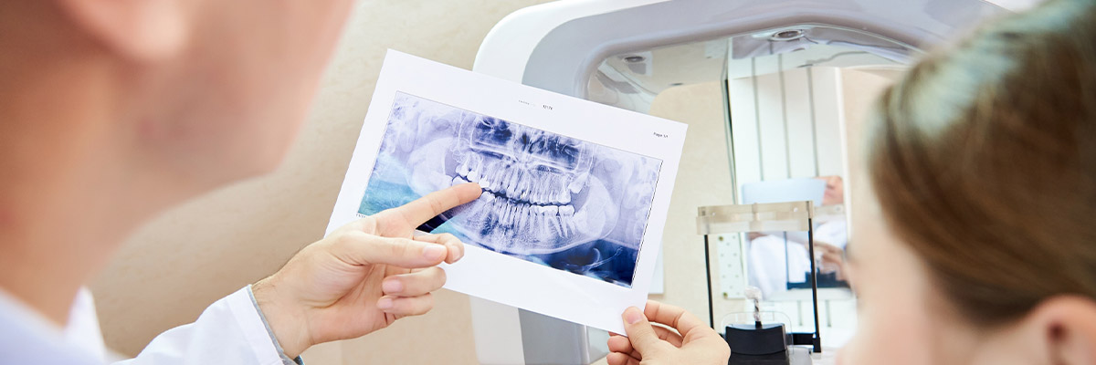 Dentist and female patient looking at x-rays